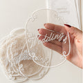 Sheer embroidered wedding invitation overlay with white thread lettering and ornate border for custom luxury wedding stationery.